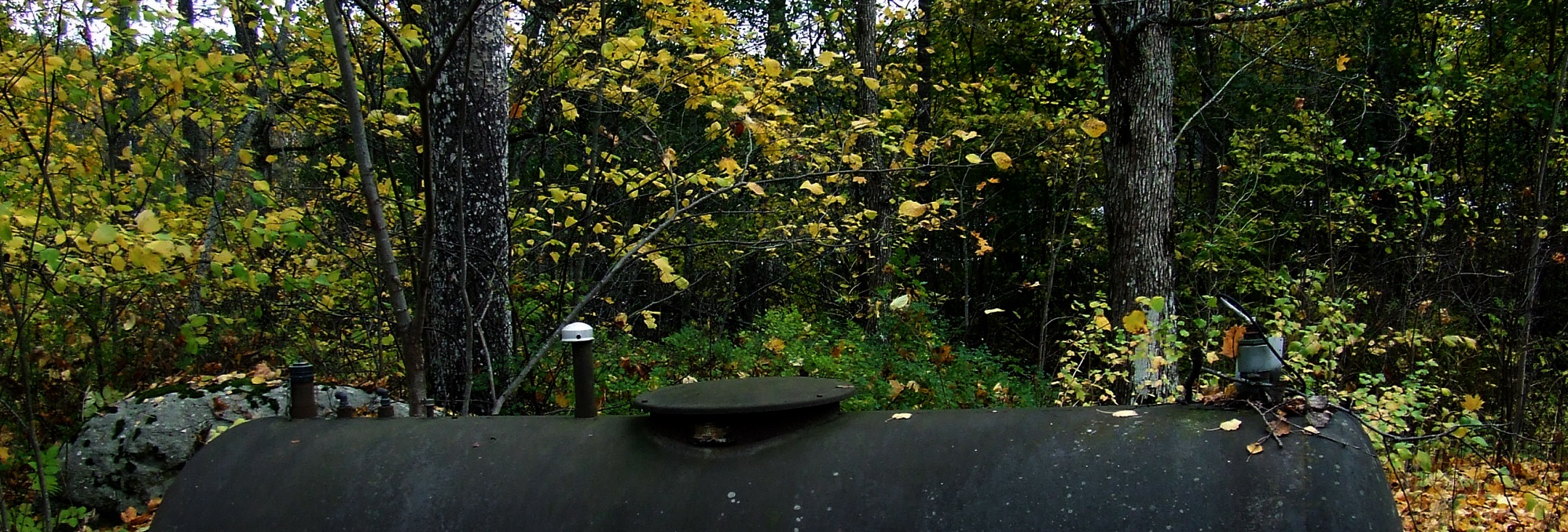 An image of the top half of a large, black oil tank.