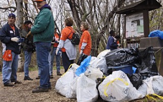 A volunteer with trash that they picked up.