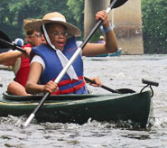 Two people in a canoe paddling in the water.