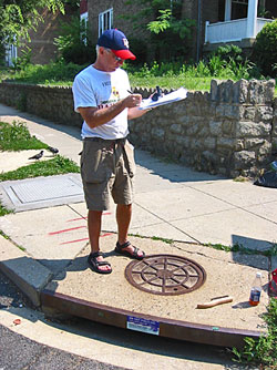 Man standing on a storm drain