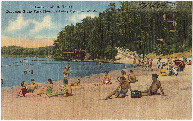 An image of a postcard that shows people lying on the beach in bathing suits.