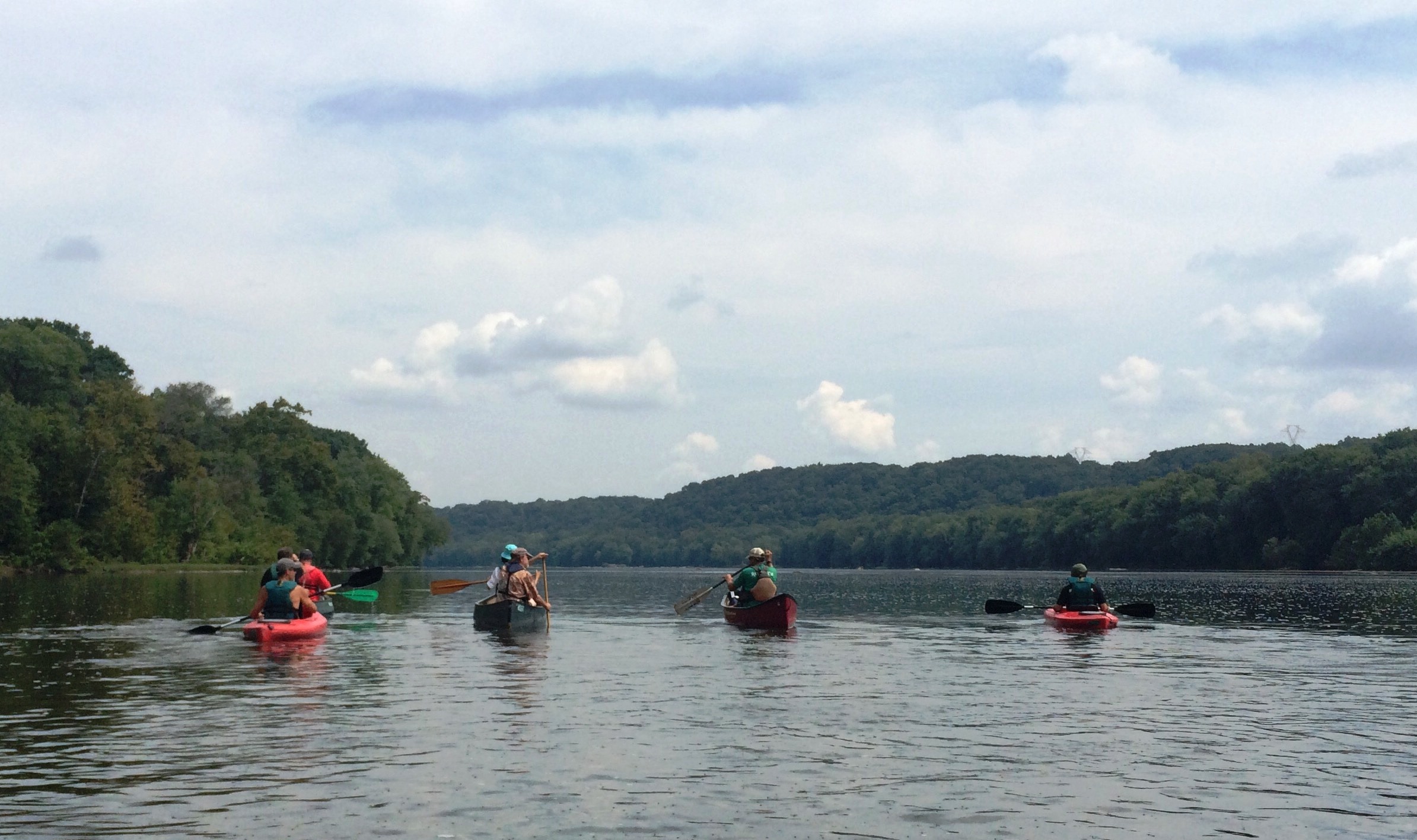 Four kayakers are seen from behind as they paddle down the Potomac River near Brunswick, Md.