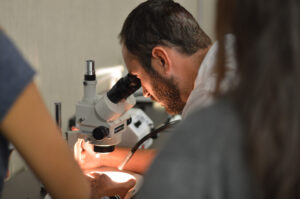 A man looking into a microscope.